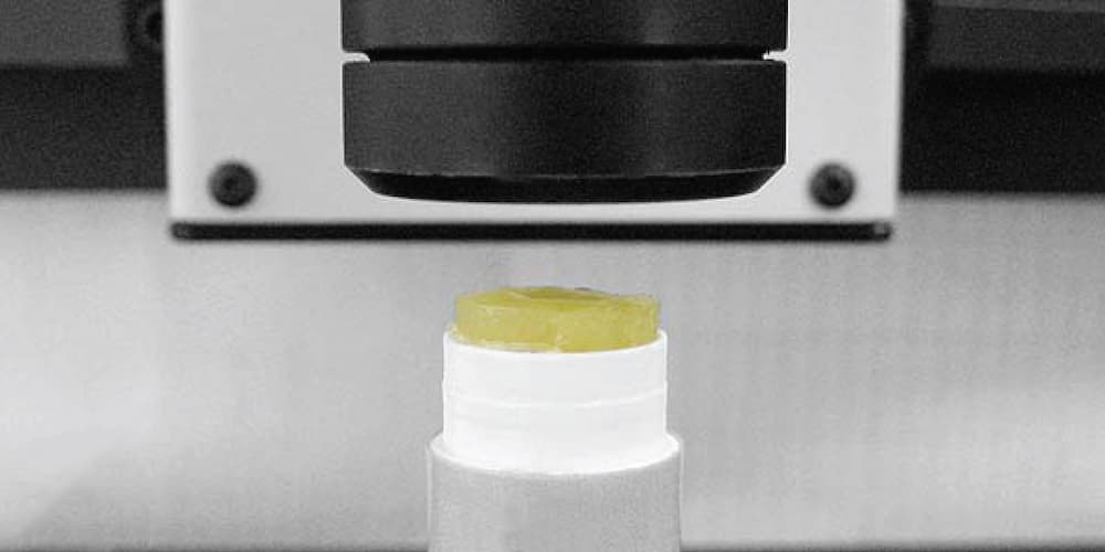 Soft transparent petroleum-jelly-based sample positioned under the NANOVEA ST400 profilometer for non-contact surface measurement